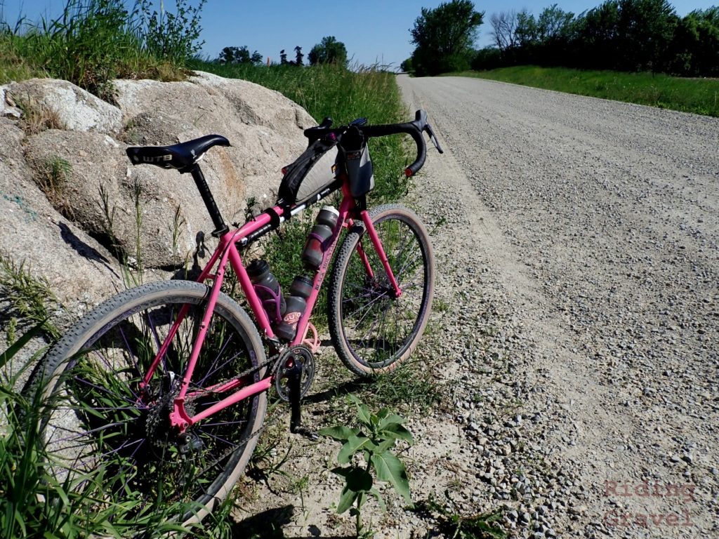 The Black Mountain Cycles MCD and Spinergy GX wheels leaning against a big rock on a rural gravel road.