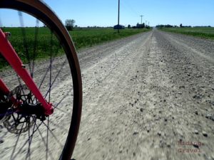 A view of a wheel on a gravel road