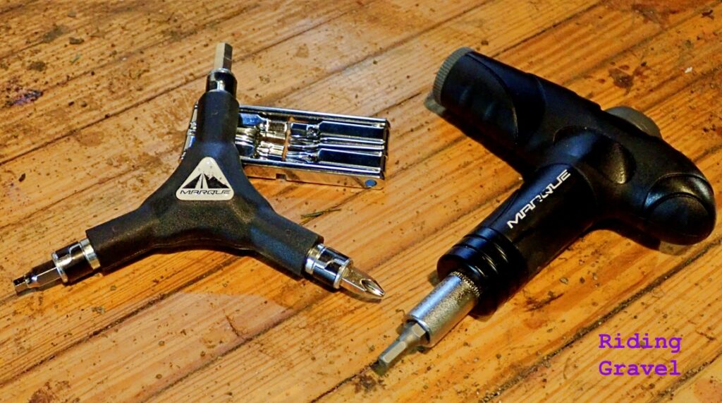 Three Marque Cycling brand tools on a bench