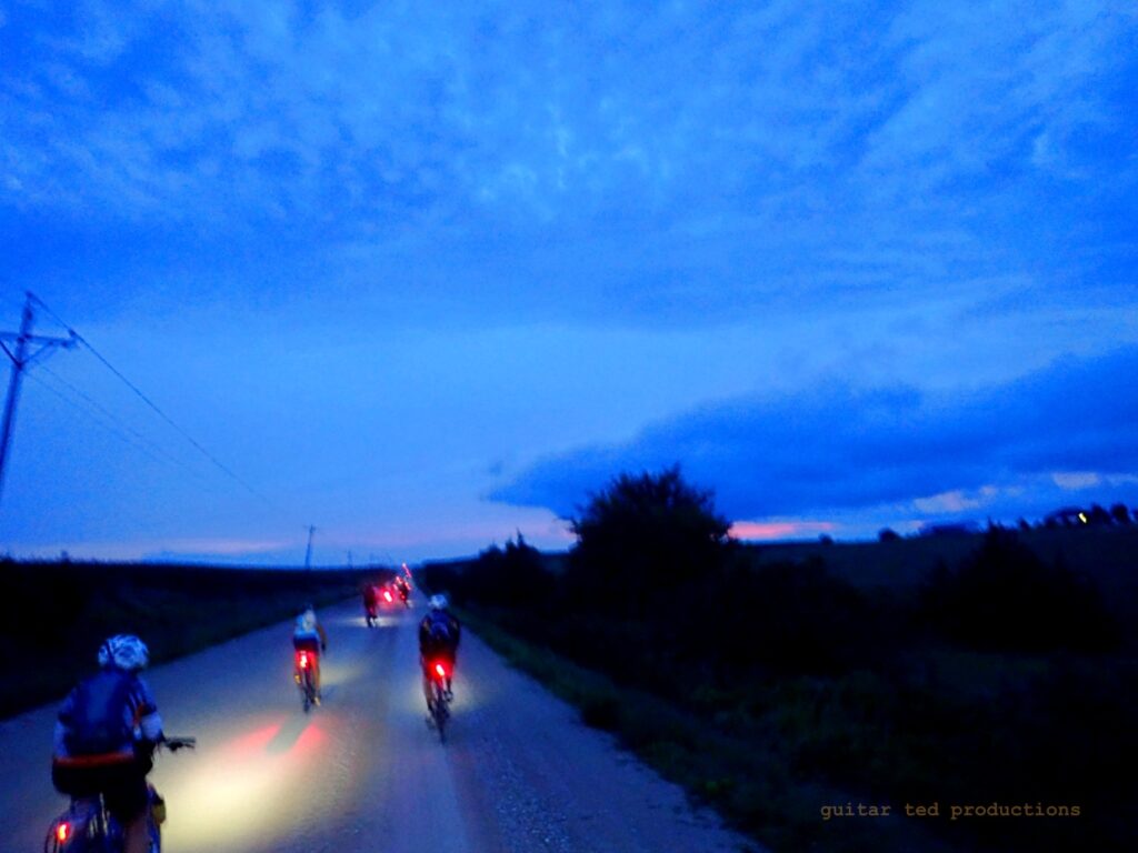 Riders on rural road at dawn